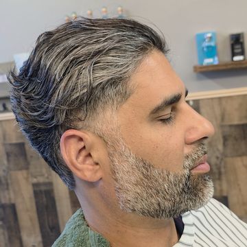 Textured medium-length haircut with a shaped beard